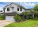 Charming two-story home with well-maintained lawn, lush landscaping, attached garage, and modern architectural design at 2610 Florence Dr, Kissimmee, FL 34744