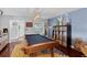 Game room with blue walls, pool table, vintage light fixture, and record storage at 2610 Florence Dr, Kissimmee, FL 34744