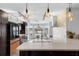Modern kitchen featuring updated appliances, a breakfast bar, and a scenic view of the waterfront at 2610 Florence Dr, Kissimmee, FL 34744