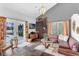 Bright living room featuring stylish decor, modern light fixture, lake views, and access to the outdoor patio at 2610 Florence Dr, Kissimmee, FL 34744