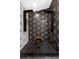 Shower featuring dual shower heads, bench, geometric tile floors, and modern finishes at 2610 Florence Dr, Kissimmee, FL 34744