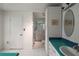 Clean bathroom with tile floors, shower and blue countertops at 27113 Robertson Rd, Yalaha, FL 34797