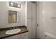 Bathroom with white tile, large mirror, and ample storage space at 27113 Robertson Rd, Yalaha, FL 34797