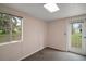 Bedroom with window and outdoor access door, providing ample natural light and backyard access at 27113 Robertson Rd, Yalaha, FL 34797