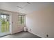 Bedroom with window and outdoor access door, providing ample natural light and backyard access at 27113 Robertson Rd, Yalaha, FL 34797