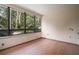 Bright bedroom with hardwood floors and a large window overlooking lush greenery at 27113 Robertson Rd, Yalaha, FL 34797
