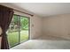 Bedroom with sliding glass door to the green outdoors at 27113 Robertson Rd, Yalaha, FL 34797