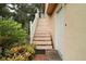 Staircase leading to an upper level door with mature landscaping at 27113 Robertson Rd, Yalaha, FL 34797