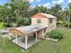 Aerial view of a two-story home with a covered parking and a spacious backyard at 27113 Robertson Rd, Yalaha, FL 34797