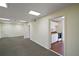 Hallway with tile floor, leading to rooms including a kitchen with white cabinetry and appliances at 27113 Robertson Rd, Yalaha, FL 34797
