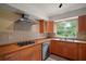 Well-equipped kitchen features stainless appliances and wooden cabinetry at 27113 Robertson Rd, Yalaha, FL 34797