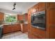 Modern kitchen features stainless appliances, built in oven and wood cabinets at 27113 Robertson Rd, Yalaha, FL 34797