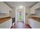 Kitchen with white cabinets, butcher block counters, and a view of the green backyard at 27113 Robertson Rd, Yalaha, FL 34797