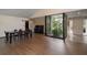 Spacious living room with modern floors, courtyard view and a grand piano at 27113 Robertson Rd, Yalaha, FL 34797