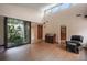 Inviting living room features a garden atrium and sleek hardwood flooring at 27113 Robertson Rd, Yalaha, FL 34797