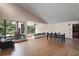 Bright living room with floor-to-ceiling windows and dining area at 27113 Robertson Rd, Yalaha, FL 34797