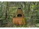 Rustic outdoor brick oven surrounded by lush greenery for alfresco cooking and dining at 27113 Robertson Rd, Yalaha, FL 34797