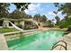 Outdoor pool next to home with slide and ladder amidst lush greenery at 27113 Robertson Rd, Yalaha, FL 34797