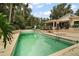 An inground backyard pool provides a tranquil focal point by home at 27113 Robertson Rd, Yalaha, FL 34797