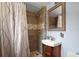 Nicely tiled bathroom featuring a shower, vanity, and modern fixtures at 27212 Orange Ave, Yalaha, FL 34797