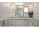 Bathroom with granite counters, lovely vanity and bright lighting at 27212 Orange Ave, Yalaha, FL 34797