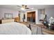 Well-lit bedroom featuring wood flooring, a wood-burning stove, and a decorative rug at 27212 Orange Ave, Yalaha, FL 34797