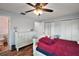 Spacious bedroom with wood flooring, ceiling fan and bright lighting at 27212 Orange Ave, Yalaha, FL 34797