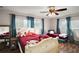 Bedroom with wood flooring, ceiling fan, and natural light from two windows at 27212 Orange Ave, Yalaha, FL 34797