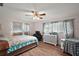Bright bedroom with wood flooring, ceiling fan and plenty of natural light at 27212 Orange Ave, Yalaha, FL 34797
