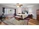 Spacious bedroom with a ceiling fan, window, and an ornate oriental rug on hardwood flooring at 27212 Orange Ave, Yalaha, FL 34797