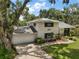 Two-story brick home with attached garage, mature landscaping, and a well-maintained lawn at 27212 Orange Ave, Yalaha, FL 34797