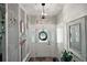 Welcoming foyer featuring decorative front door, modern light fixture, and bright white walls at 27212 Orange Ave, Yalaha, FL 34797