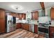Bright kitchen featuring stainless steel appliances, hardwood floors, and granite countertops at 27212 Orange Ave, Yalaha, FL 34797
