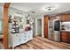 Bright kitchen featuring stainless steel appliances, a coffee bar and wood look floors at 27212 Orange Ave, Yalaha, FL 34797