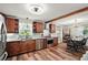 Modern kitchen with stainless steel appliances, granite countertops, and wood-look flooring at 27212 Orange Ave, Yalaha, FL 34797