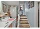 Functional laundry area with washer, dryer, and shelving, leading to carpeted stairs at 27212 Orange Ave, Yalaha, FL 34797