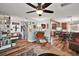 Bright living room showcasing wood floors, a staircase, and an open view into the kitchen at 27212 Orange Ave, Yalaha, FL 34797
