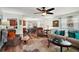 Spacious living room with plenty of seating, natural light, and modern decor elements at 27212 Orange Ave, Yalaha, FL 34797