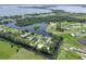 Scenic aerial view showcasing homes along a canal leading to a picturesque lake at 29152 David Ct, Tavares, FL 32778