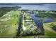 Wide aerial view of a waterfront community featuring houses along canals and lakes at 29152 David Ct, Tavares, FL 32778