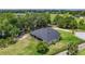 Aerial view showcasing the home's screened porch, spacious lot, and golf course views at 29152 David Ct, Tavares, FL 32778