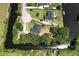 Stunning aerial view of the property featuring expansive waterfront, lush greenery, and private docks at 29152 David Ct, Tavares, FL 32778