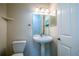 Bathroom featuring a pedestal sink and a white toilet with light walls at 29152 David Ct, Tavares, FL 32778