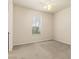 Cozy bedroom featuring a large window with blinds, neutral carpet, and ample natural light at 29152 David Ct, Tavares, FL 32778