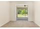 Neutral carpeted bedroom features an open entrance to a screened porch at 29152 David Ct, Tavares, FL 32778