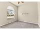 Bright bedroom features a large arched window and neutral carpeting, perfect for relaxation at 29152 David Ct, Tavares, FL 32778