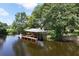 Picturesque boat dock with a covered platform, set against a tranquil waterfront backdrop at 29152 David Ct, Tavares, FL 32778