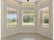 Sunny breakfast nook with multiple windows offering tranquil backyard views, perfect for morning coffee at 29152 David Ct, Tavares, FL 32778