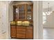 Elegant dining area featuring a built-in wood cabinet and tiled backsplash, with a view to the living space at 29152 David Ct, Tavares, FL 32778