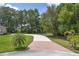 Long, winding driveway leading to the home, surrounded by mature trees and landscaping at 29152 David Ct, Tavares, FL 32778